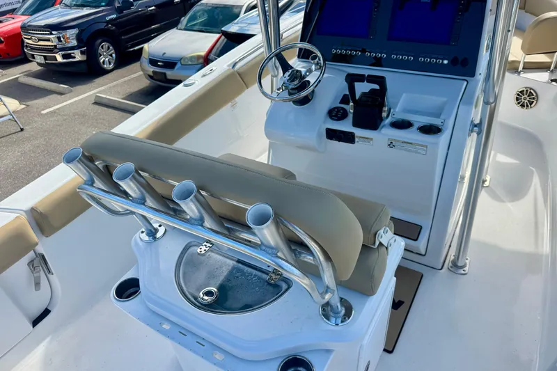 Slide: The Image of 2017 Sportsman Heritage 251 Center Console boat interior with steering and rod holders. - 19