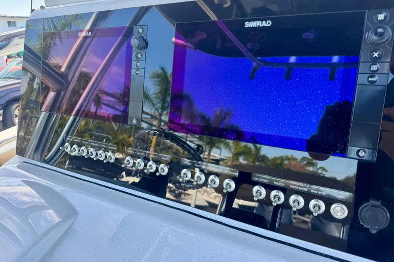 Slide: The Image of 2017 Sportsman Heritage 251 Center Console dashboard with Simrad displays and control switches. - 22