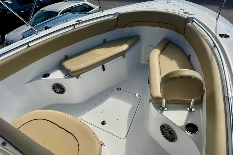 Slide: The Image of 2017 Sportsman Heritage 251 Center Console boat interior with tan seating and cup holders. - 25
