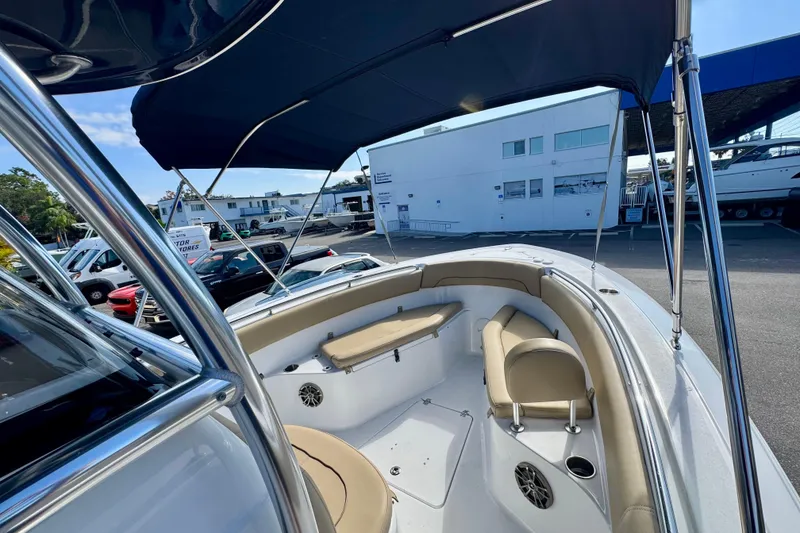 Slide: The Image of 2017 Sportsman Heritage 251 Center Console boat with seating and canopy in a marina setting. - 26