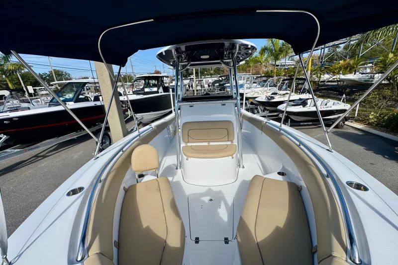 Slide: The Image of 2017 Sportsman Heritage 251 Center Console boat with tan seating and canopy. - 28