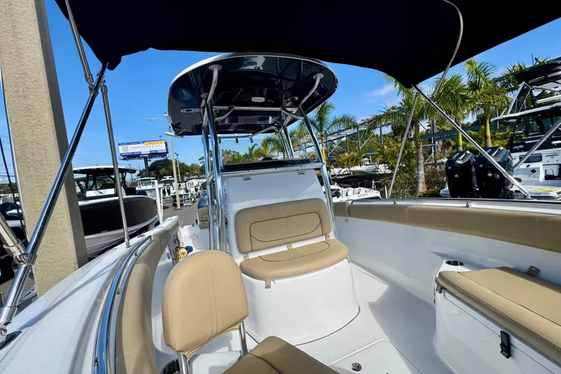 Slide: The Image of 2017 Sportsman Heritage 251 Center Console boat interior with seating and canopy. - 31