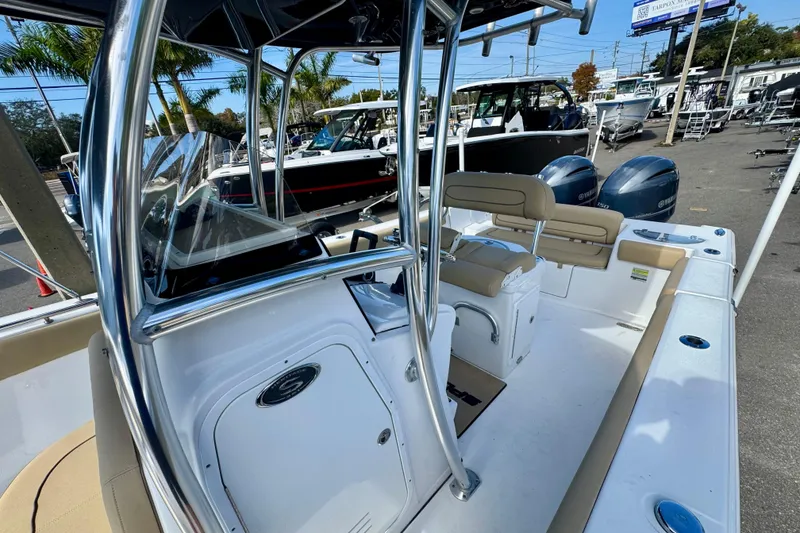 Slide: The Image of 2017 Sportsman Heritage 251 Center Console boat with dual engines, docked outdoors. - 34