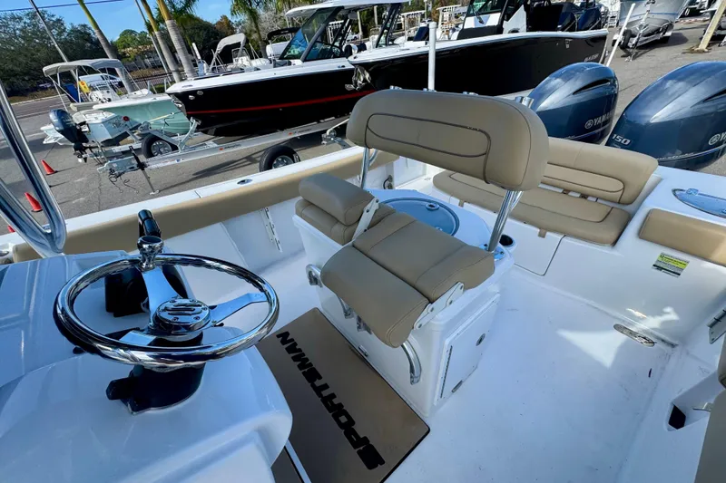 Slide: The Image of 2017 Sportsman Heritage 251 Center Console boat interior with steering wheel and seating. - 35