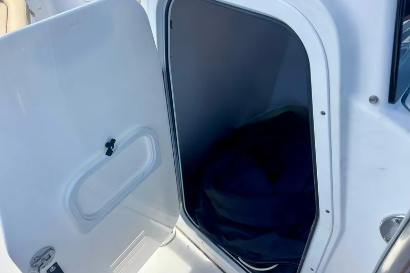 Slide: The Image of Open storage compartment on 2017 Sportsman Heritage 251 Center Console boat. - 39