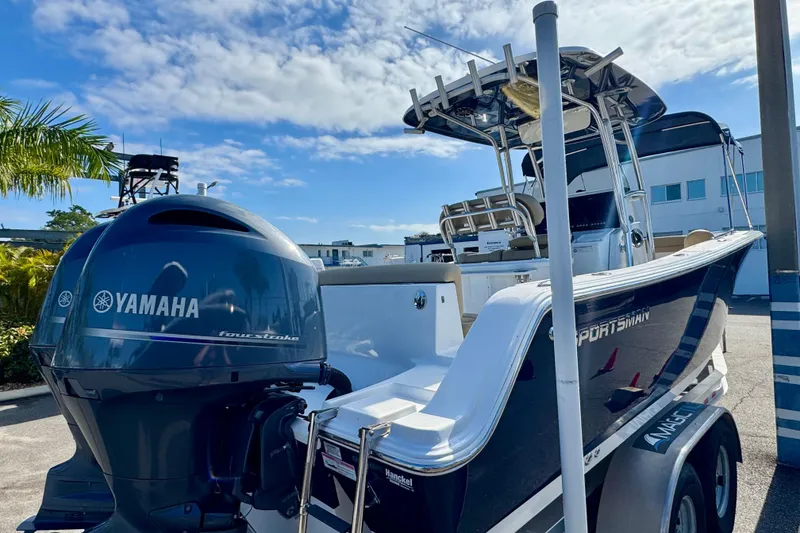 Slide: The Image of 2017 Sportsman Heritage 251 Center Console boat with Yamaha engine, docked under blue sky. - 6