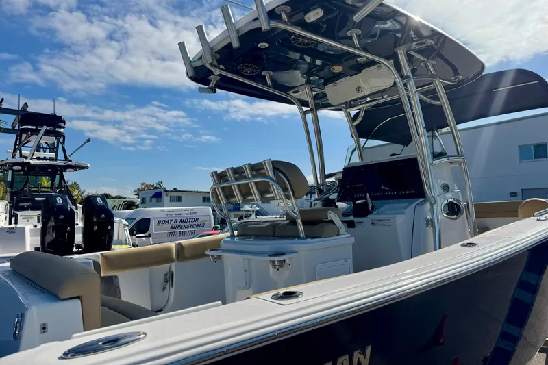 Slide: The Image of 2017 Sportsman Heritage 251 Center Console boat with dual engines, docked under a sunny sky. - 8