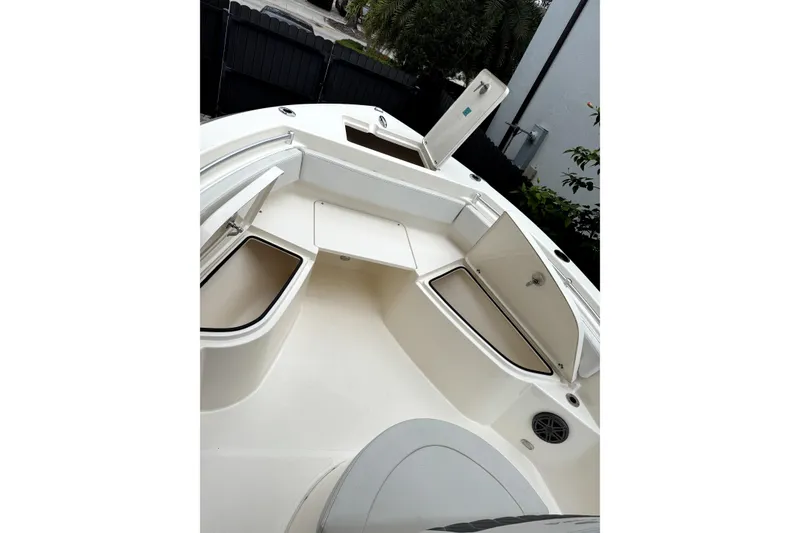 Slide: The Image of 2022 Cobia 220 Center Console boat with Yamaha engine on trailer in parking lot. - 10