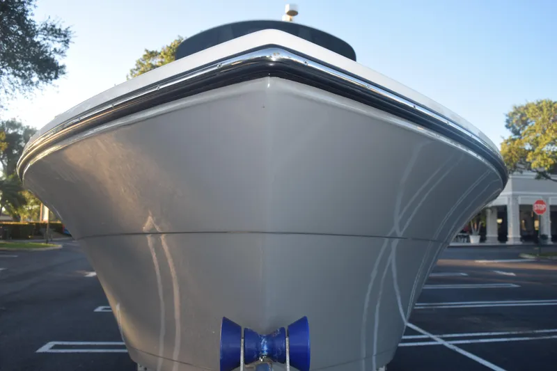 Slide: The Image of 2022 Cobia 220 Center Console boat, front view in a parking lot. - 15