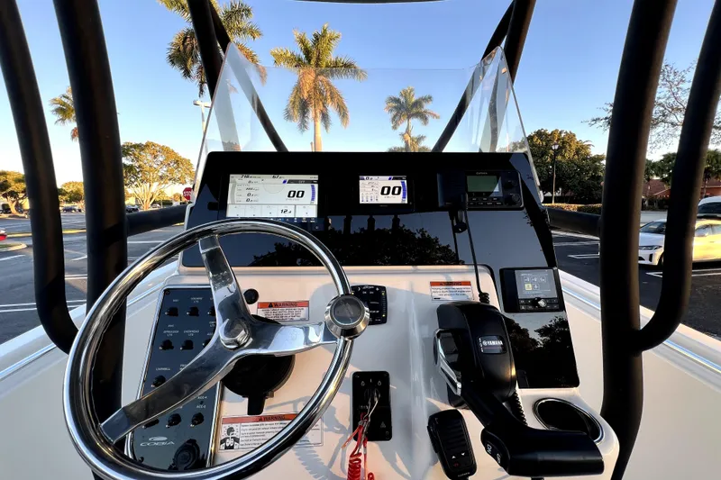 Slide: The Image of 2022 Cobia 220 Center Console boat dashboard with steering wheel and controls. - 23
