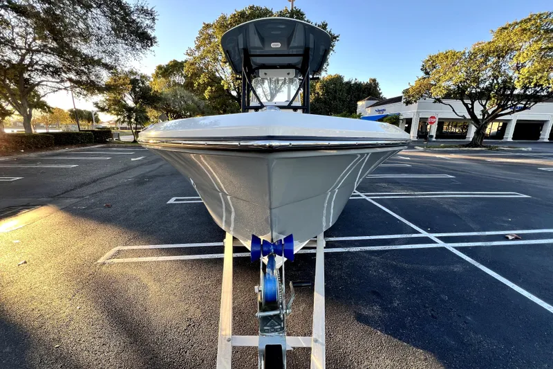 Slide: The Image of 2022 Cobia 220 Center Console boat on trailer in parking lot, sunny day. - 25