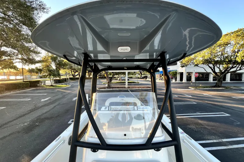 Slide: The Image of 2022 Cobia 220 Center Console boat with T-top in a parking lot. - 28