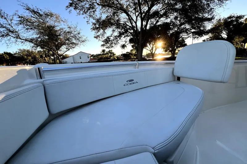 Slide: The Image of 2022 Cobia 220 Center Console boat interior with sunset view. - 29