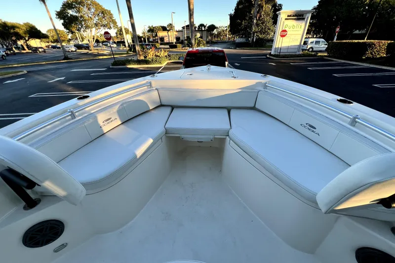 Slide: The Image of 2022 Cobia 220 Center Console boat with spacious seating in a parking lot. - 30