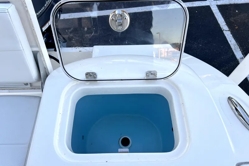 Slide: The Image of Open storage compartment on 2022 Cobia 220 Center Console boat. - 32