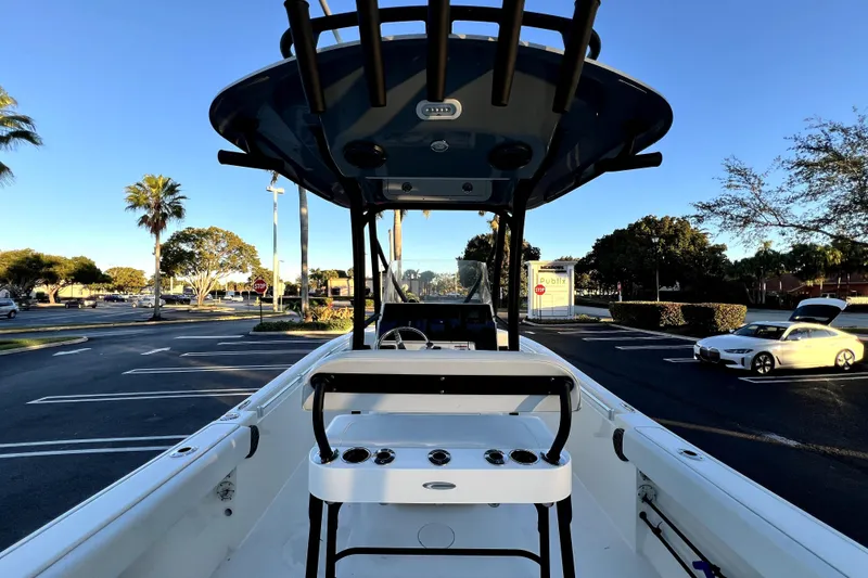 Slide: The Image of 2022 Cobia 220 Center Console boat in parking lot, sunny day, palm trees in background. - 33