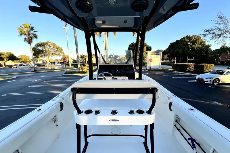 Slide: The Image of 2022 Cobia 220 Center Console boat in a parking lot, showcasing helm and seating area. - 35