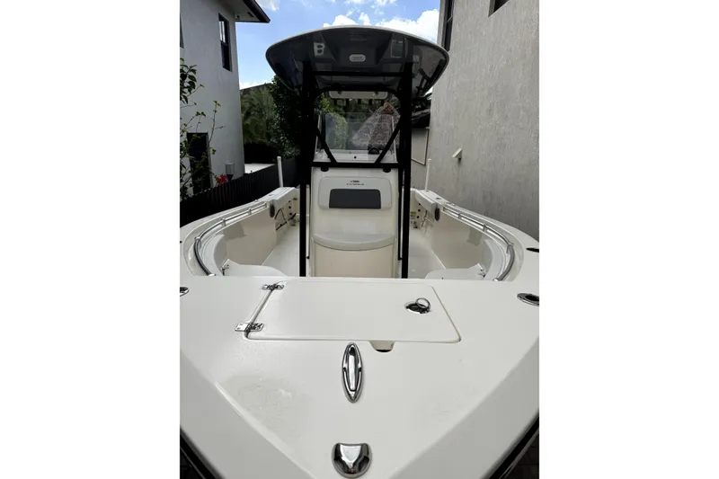 Slide: The Image of 2022 Cobia 220 Center Console boat with Yamaha 200 engine in parking lot. - 4