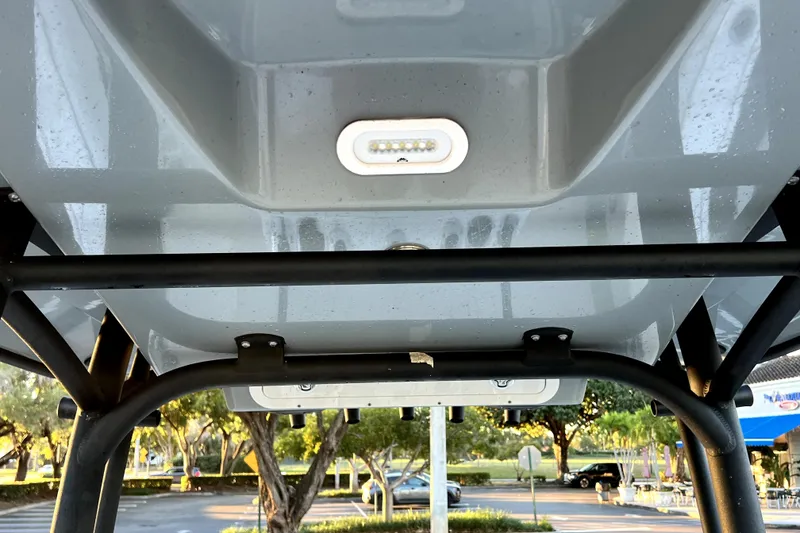 Slide: The Image of 2022 Cobia 220 Center Console boat T-top with integrated LED light. - 40