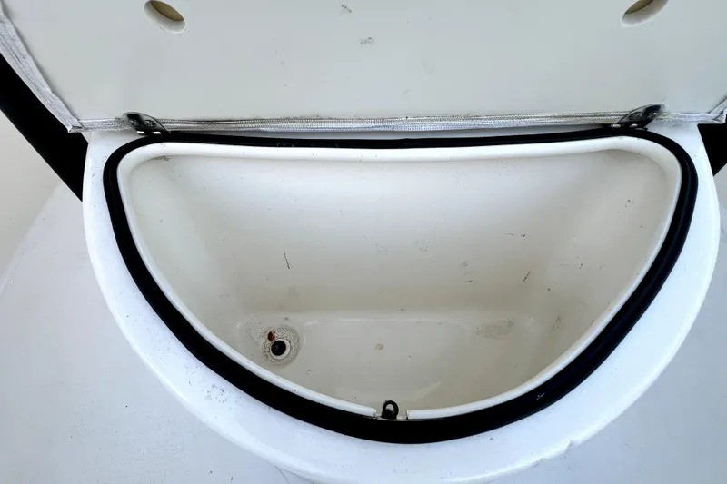 Slide: The Image of Open storage compartment on 2022 Cobia 220 Center Console boat. - 43