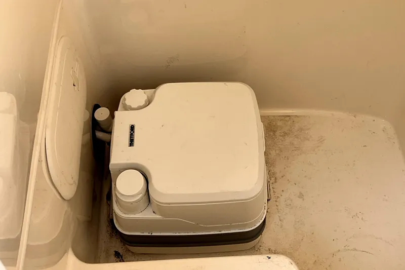 Slide: The Image of Portable toilet in 2022 Cobia 220 Center Console boat compartment. - 45