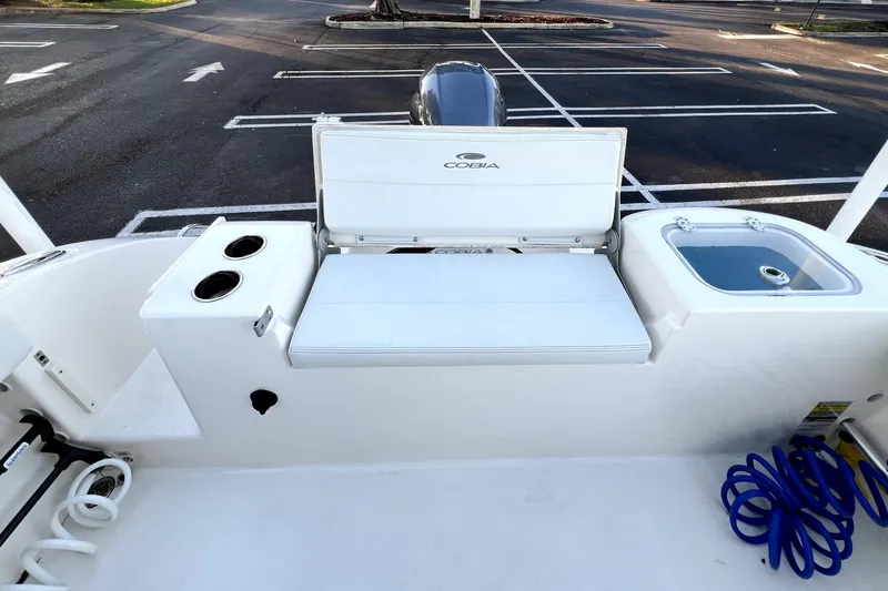 Slide: The Image of 2022 Cobia 220 Center Console boat interior with seating and storage features. - 49