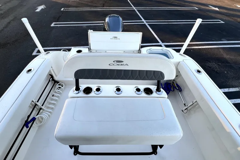 Slide: The Image of 2022 Cobia 220 Center Console boat interior with seating and rod holders. - 51