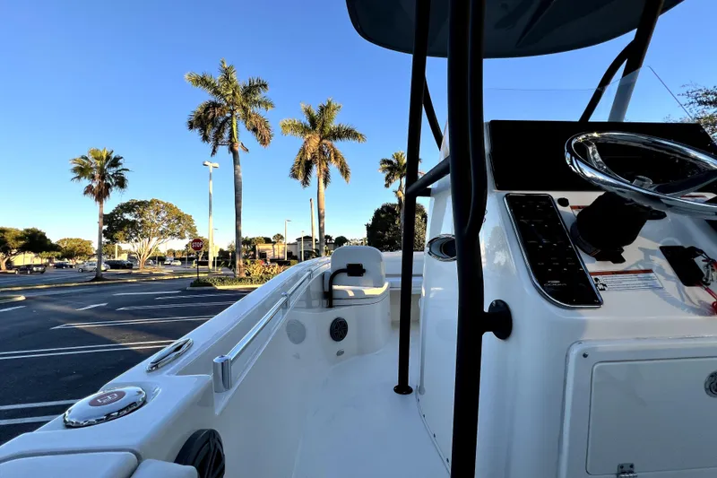 Slide: The Image of 2022 Cobia 220 Center Console boat with palm trees in the background. - 52