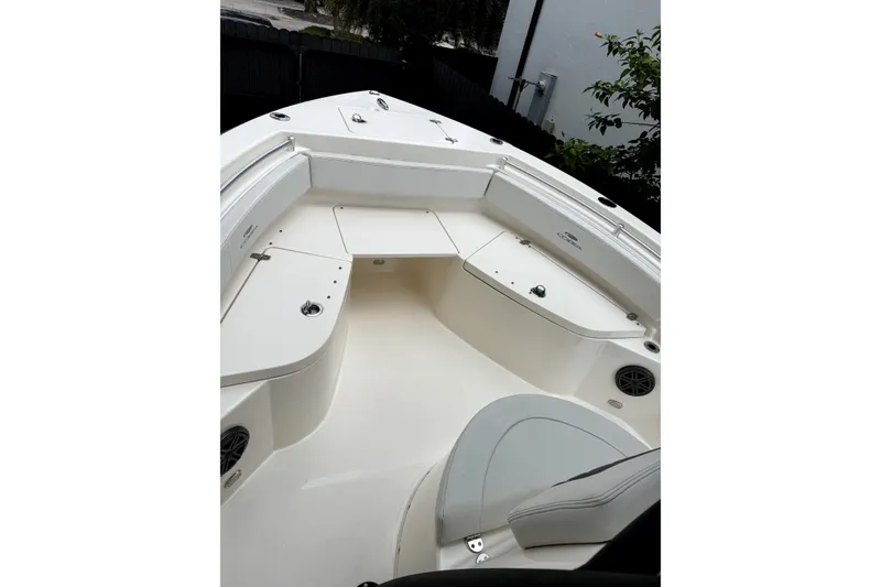 Slide: The Image of 2022 Cobia 220 Center Console boat with Yamaha engine in a parking lot. - 9