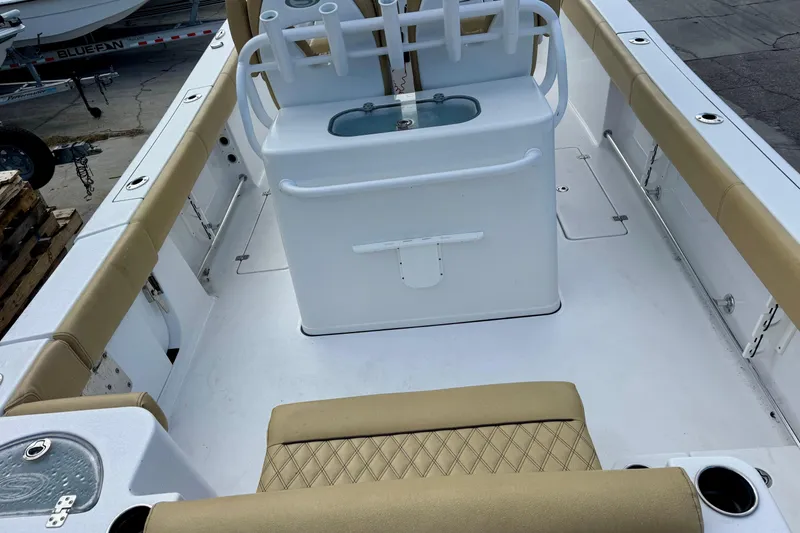 Slide: The Image of 2021 Sportsman Open 282 Center Console boat interior with tan seating and white console. - 10