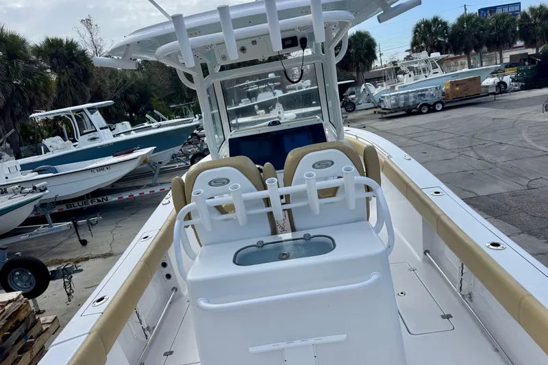 Slide: The Image of 2021 Sportsman Open 282 Center Console boat at a marina with other vessels. - 11