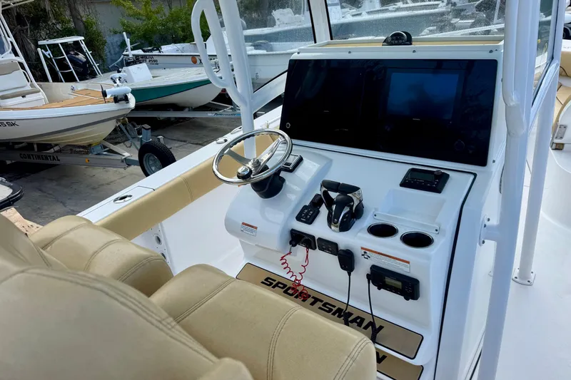 Slide: The Image of 2021 Sportsman Open 282 Center Console boat interior with steering wheel and control panel. - 17