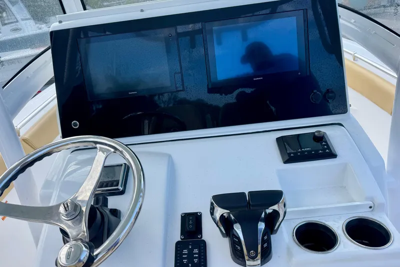 Slide: The Image of 2021 Sportsman Open 282 Center Console dashboard with steering wheel and dual screens. - 19