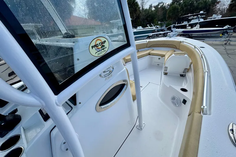 Slide: The Image of 2021 Sportsman Open 282 Center Console boat with beige seating and modern design. - 21