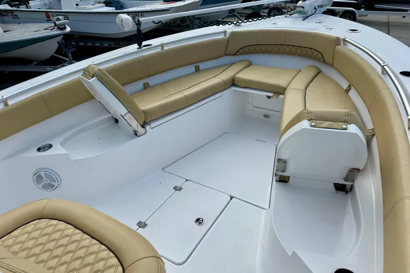 Slide: The Image of 2021 Sportsman Open 282 Center Console boat with tan cushioned seating. - 23