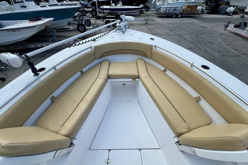 Slide: The Image of 2021 Sportsman Open 282 Center Console boat with tan seating, docked in a marina. - 24