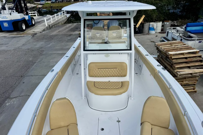 Slide: The Image of 2021 Sportsman Open 282 Center Console boat with tan seating and spacious deck. - 28