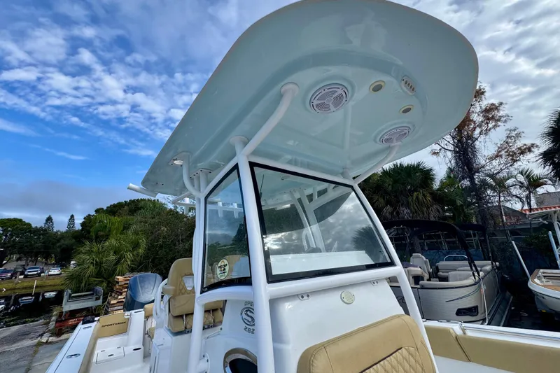 Slide: The Image of 2021 Sportsman Open 282 Center Console boat with T-top and seating, under a partly cloudy sky. - 32