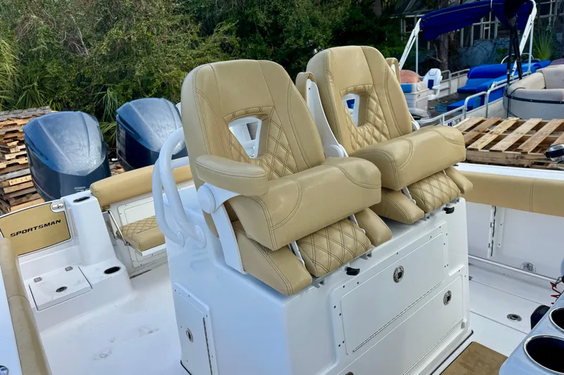 Slide: The Image of 2021 Sportsman Open 282 Center Console with tan seating and dual outboard motors. - 35