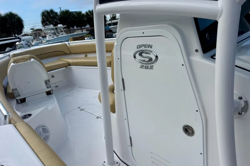 Slide: The Image of 2021 Sportsman Open 282 Center Console boat interior with tan seating and storage. - 37