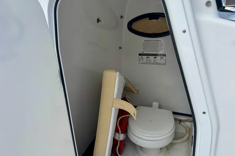 Slide: The Image of Interior of 2021 Sportsman Open 282 Center Console boat with toilet and storage. - 38