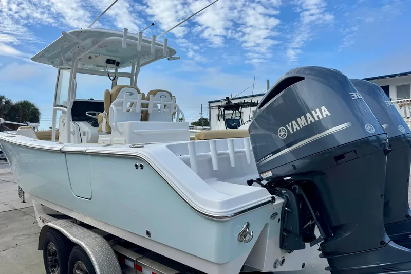 Slide: The Image of 2021 Sportsman Open 282 Center Console boat with Yamaha engines on a trailer. - 4