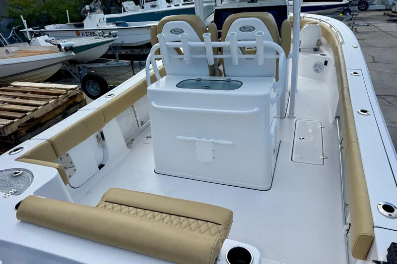 Slide: The Image of 2021 Sportsman Open 282 Center Console boat interior with tan seating and white console. - 9