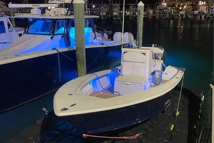 Slide: The Image of 2010 SeaCraft 20 SF boat docked at night with blue interior lighting. - 3