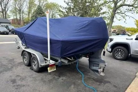 Slide: The Image of 2010 SeaCraft 20 SF boat covered on trailer, parked in driveway. - 4