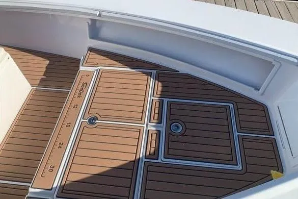 Slide: The Image of 2010 SeaCraft 20 SF boat deck with teak-style flooring and measurement markings. - 5