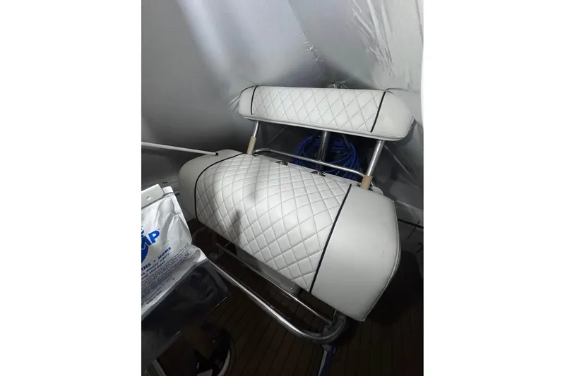 Slide: The Image of White quilted seat on 2010 SeaCraft 20 SF boat, featuring stainless steel frame. - 8