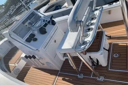 Slide: The Image of 2010 SeaCraft 20 SF boat interior with helm, fishing rod holders, and teak flooring. - 9
