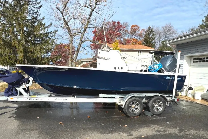 Slide: The Image of 2010 SeaCraft 20 SF boat on trailer, parked in driveway with autumn trees. - 1