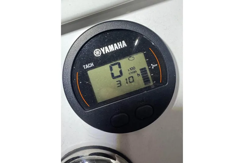Slide: The Image of Yamaha tachometer displaying 310 hours on a 2010 SeaCraft 20 SF boat. - 13